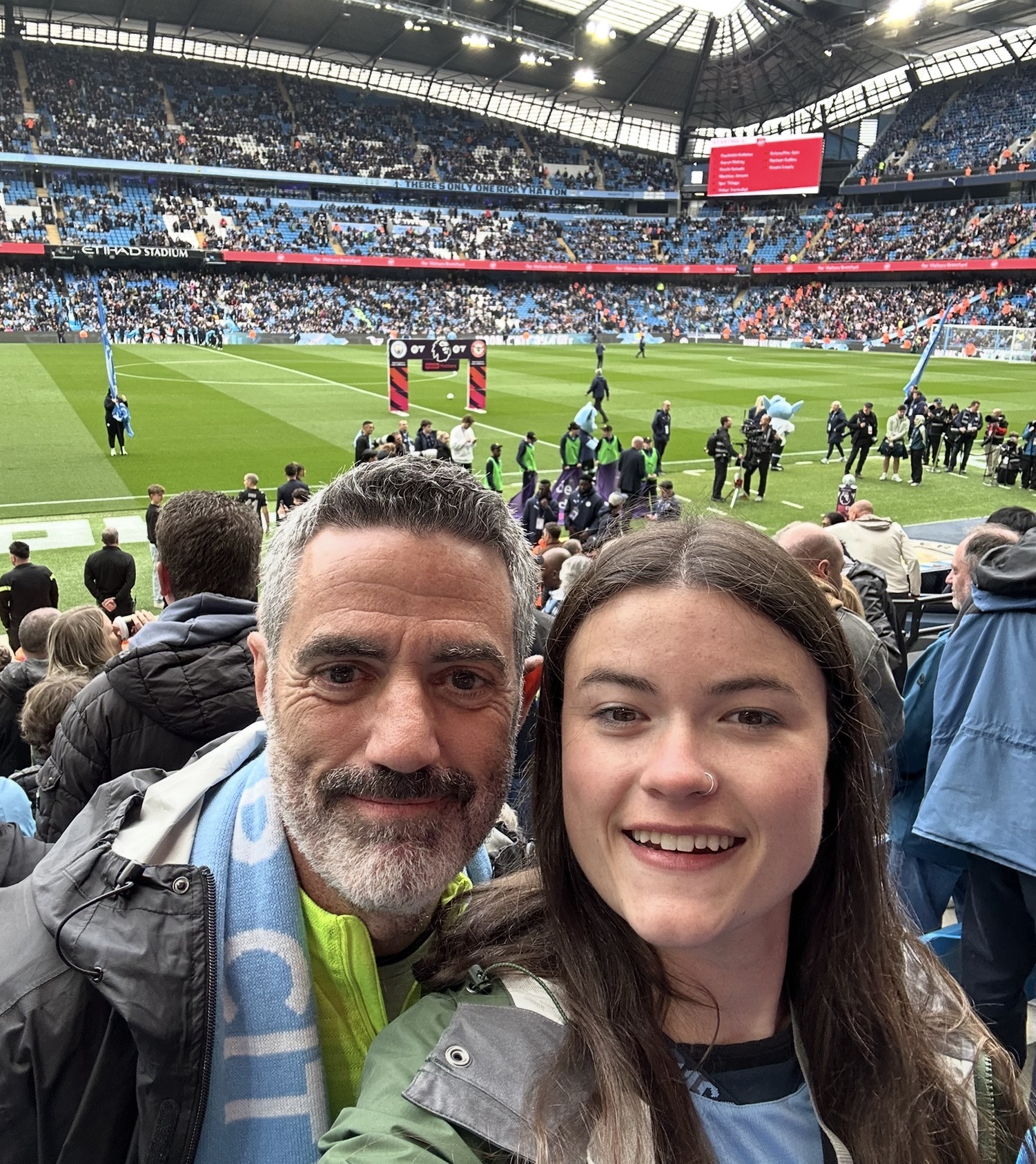 Father and daughter sharing a day at a football stadium