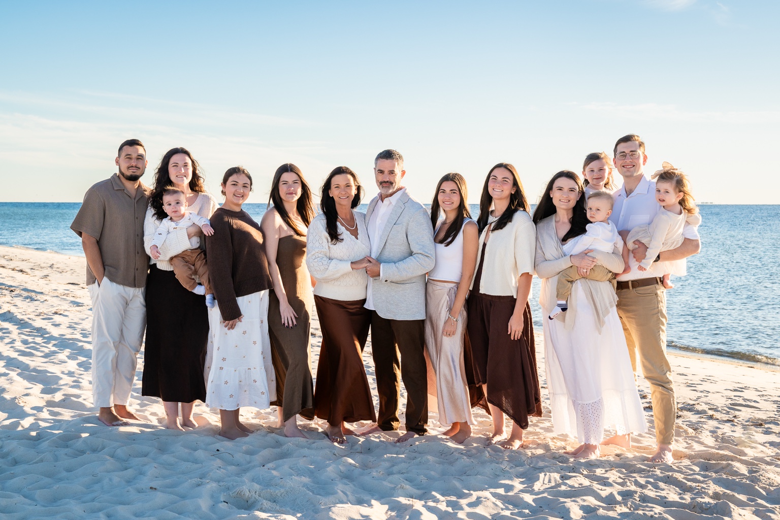 A large family gathered together on the beach