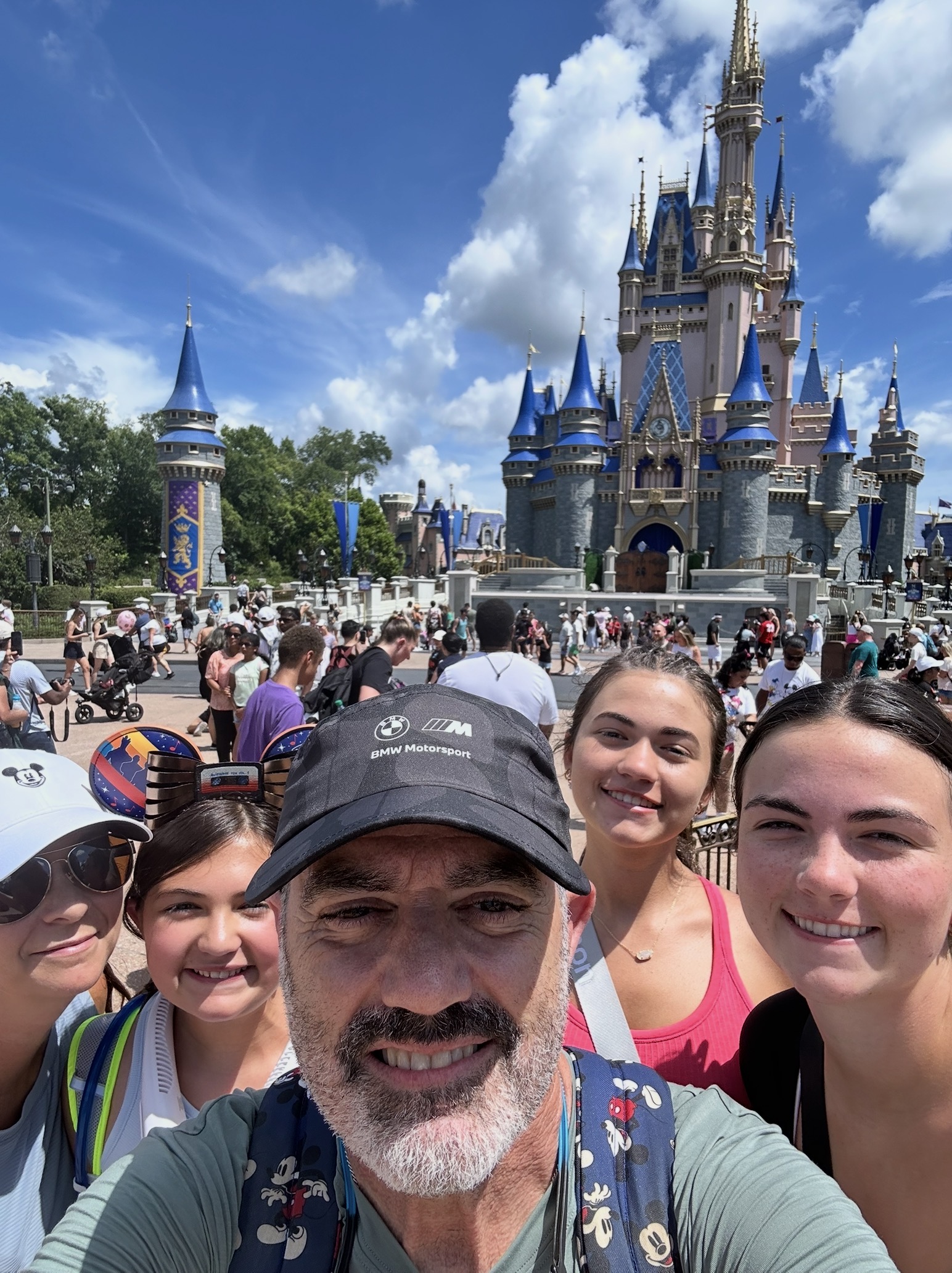 A family enjoying a sunny day together at a theme park